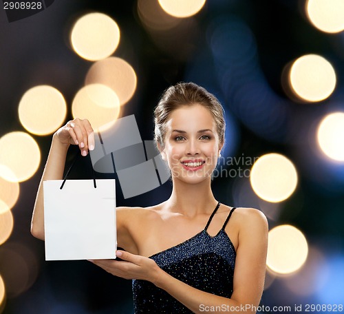 Image of smiling woman with white blank shopping bag