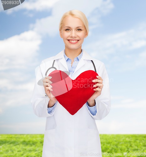 Image of smiling female doctor with heart and stethoscope