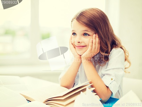 Image of student girl writing in notebook at school