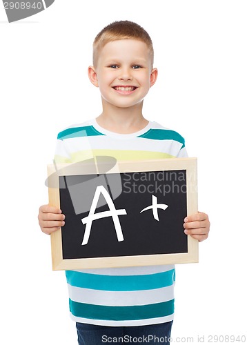 Image of smiling little boy with blank blackboard