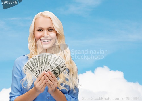 Image of smiling young woman with us dollar money