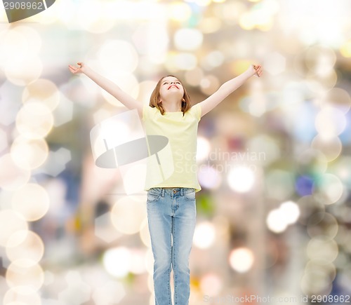 Image of smiling teenage girl with raised hands