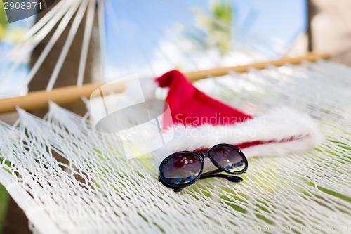 Image of hammock with santa helper hat and shades