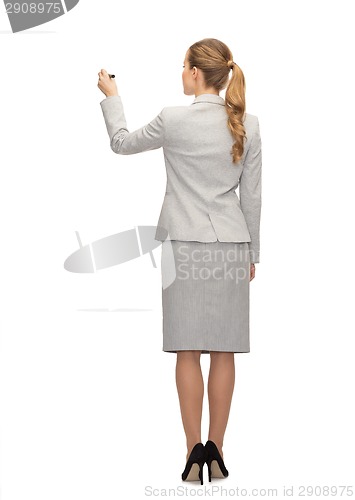 Image of businesswoman or teacher with marker from back