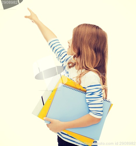 Image of little student girl with notebooks pointing to