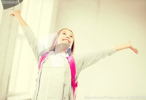 Image of happy teenage girl with raised hands