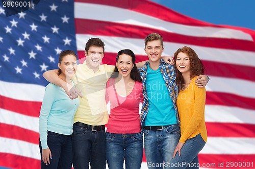 Image of group of smiling teenagers over american flag