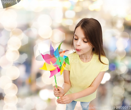 Image of smiling child with colorful windmill toy