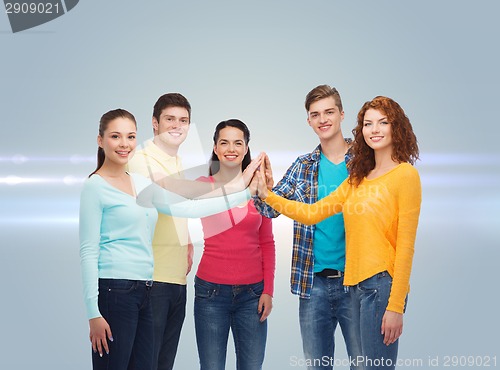 Image of smiling teenagers making high five