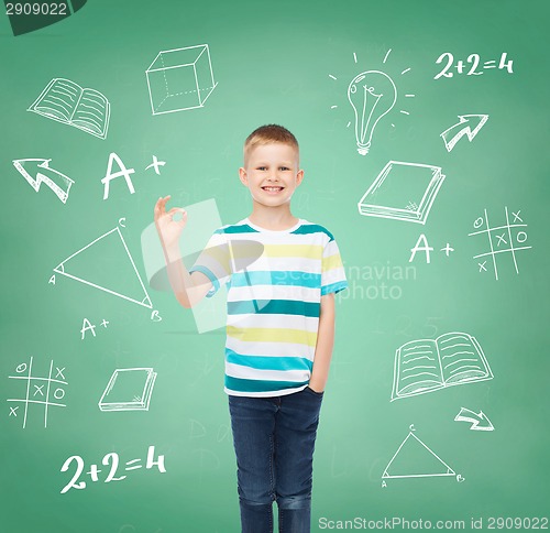 Image of little boy in casual clothes making OK gesture