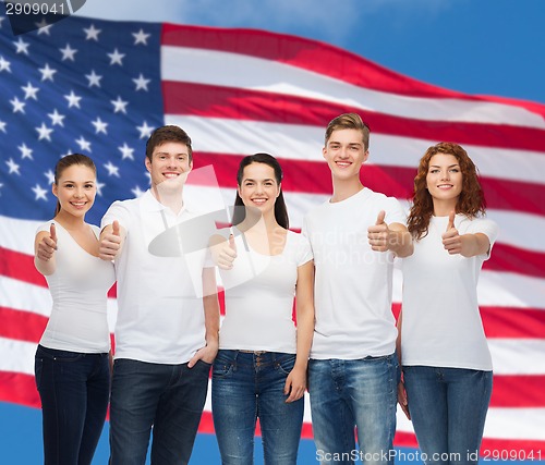 Image of smiling teenagers in t-shirts showing thumbs up