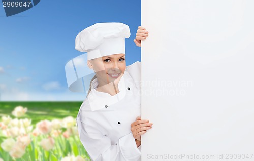 Image of smiling female chef with white blank board