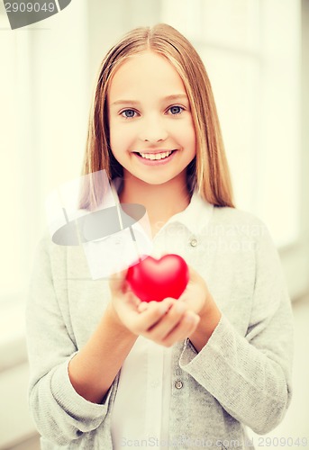 Image of beautiful teenage girl showing red heart