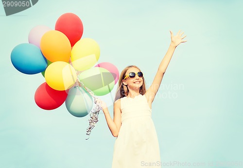 Image of happy girl with colorful balloons