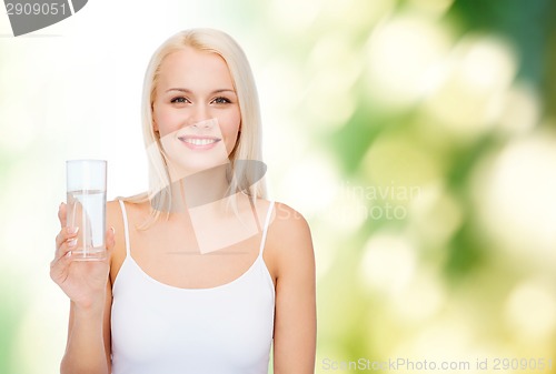 Image of young smiling woman with glass of water