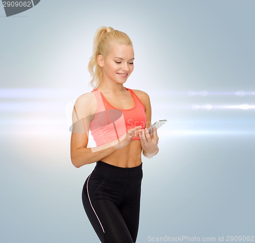 Image of smiling sporty woman with smartphone