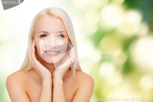 Image of beautiful woman touching her face skin
