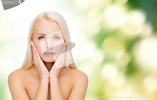 Image of beautiful woman touching her face skin
