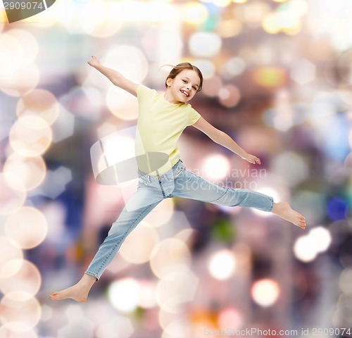 Image of smiling little girl jumping