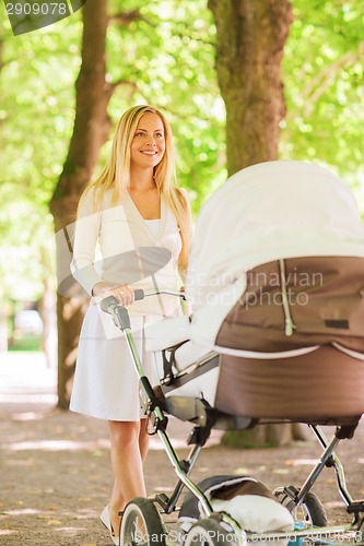 Image of happy mother with stroller in park