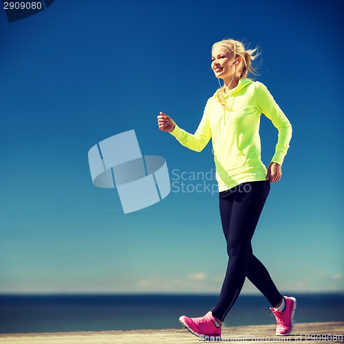 Image of woman walking outdoors