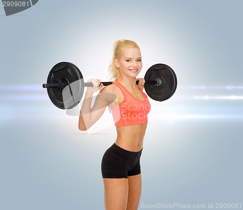 Image of smiling sporty woman exercising with barbell