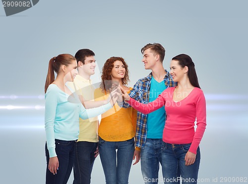 Image of smiling teenagers making high five