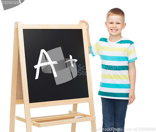 Image of smiling little boy with blank blackboard