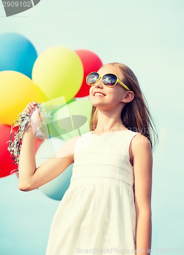 Image of happy girl with colorful balloons