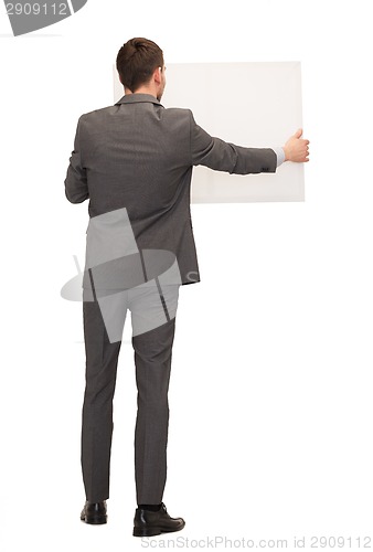 Image of businessman or teacher with white board from back