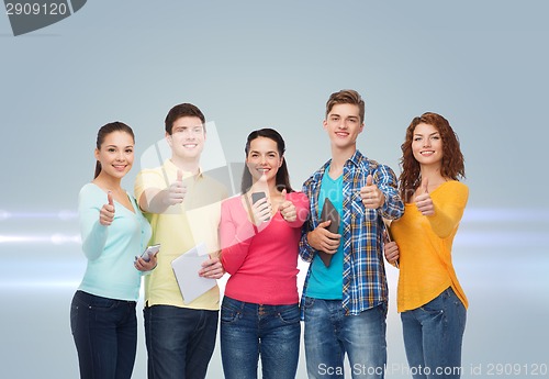 Image of group of teenagers with smartphones and tablet pc