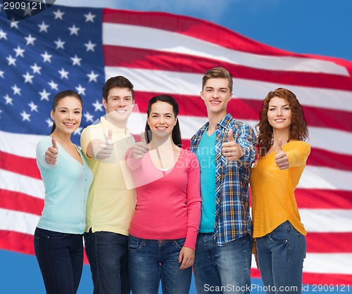 Image of group of smiling teenagers over american flag