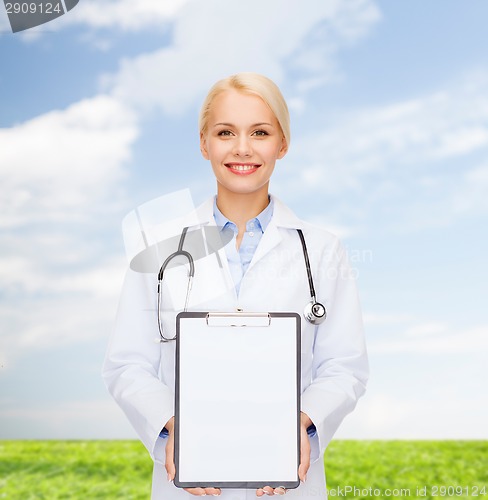 Image of smiling female doctor with clipboard