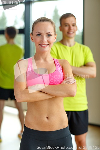 Image of smiling man and woman in gym