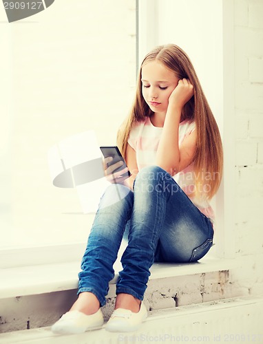 Image of girl with smartphone at school