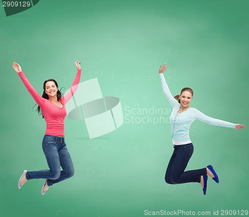 Image of smiling young women jumping in air