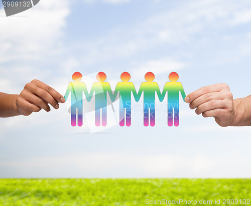 Image of close up of hands holding paper chain gay people