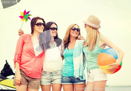 Image of smiling girls in shades having fun on the beach