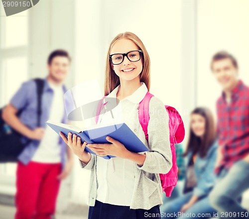 Image of girl reading book at school