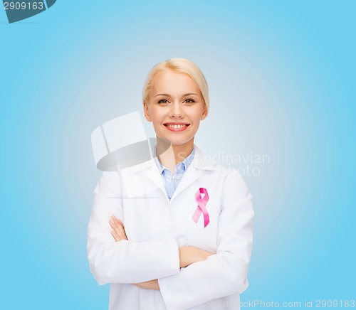 Image of smiling female doctor with cancer awareness ribbon