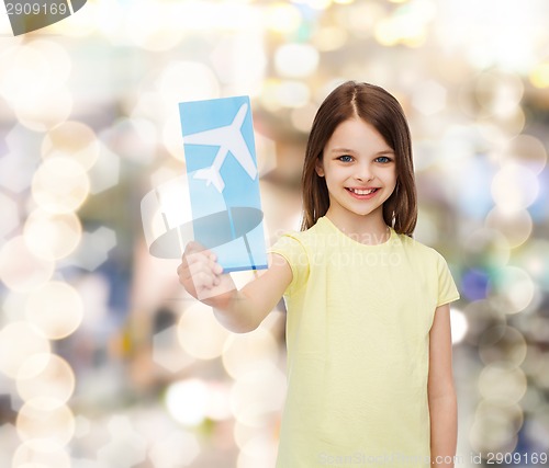 Image of smiling little girl with airplane ticket