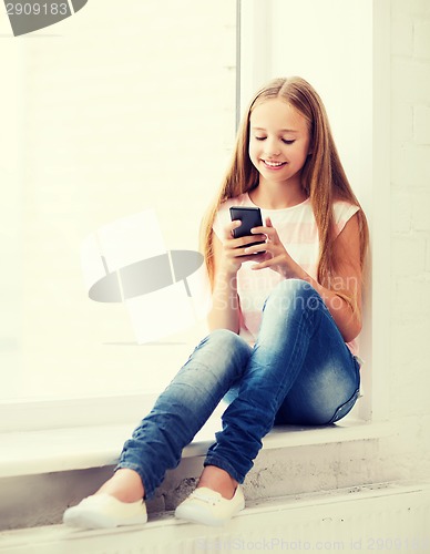 Image of girl with smartphone at school