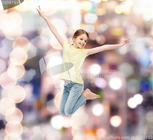 Image of smiling little girl jumping