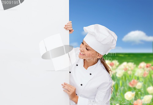 Image of smiling female chef with white blank board