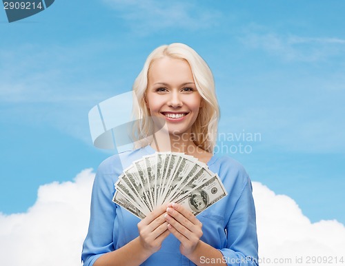 Image of smiling young woman with us dollar money