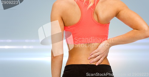 Image of close up of sporty woman touching her back