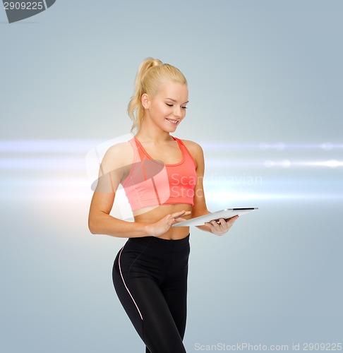 Image of smiling sporty woman with tablet pc computer