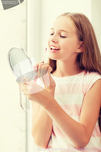 Image of teenage girl with lip gloss and mirror