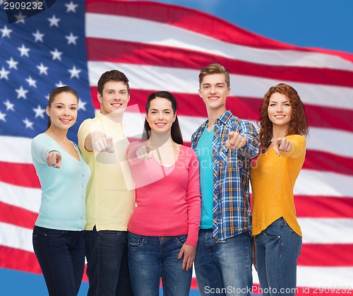 Image of group of smiling teenagers over american flag