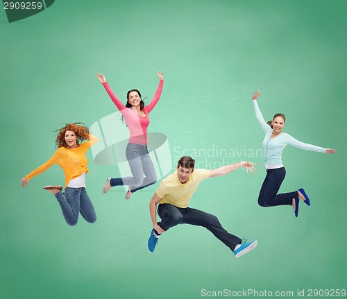 Image of group of smiling teenagers jumping in air